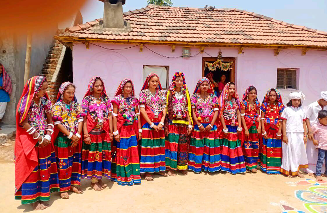 Lambadi Dance performance on stage with synchronized folk dancers in bright costume